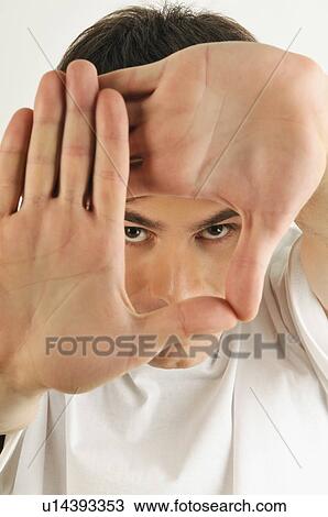 Young male adult; looking through hands View Large Photo Image Stock Image - Young male adult; looking through hands. Fotosearch