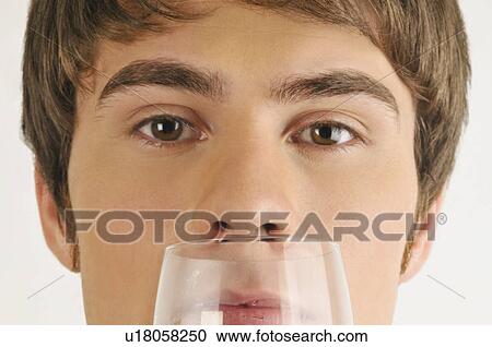 Young male adult smelling a glass of wine View Large Photo Image Stock Image - Young male adult smelling a glass of wine. Fotosearch