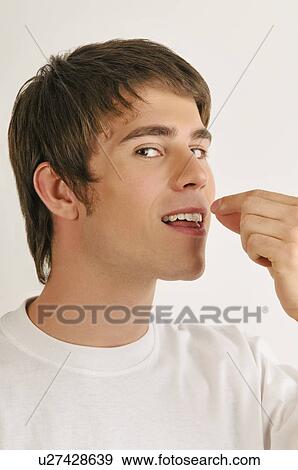 Young male adult tasting with hands View Large Photo Image Stock Photo - Young male adult tasting with hands. Fotosearch