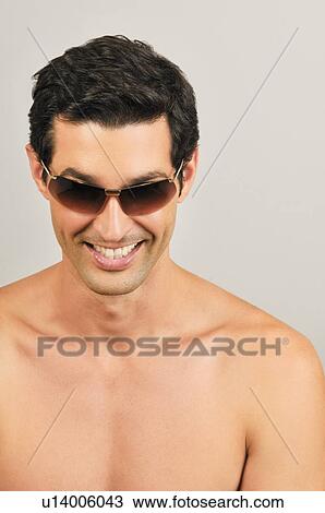 Young male adult wearing sunglasses View Large Photo Image Stock Image - Young male adult wearing sunglasses. Fotosearch
