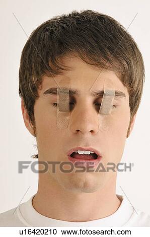 Young male adult with Band-Aids over his eyes View Large Photo Image Stock Image - Young male adult with Band-Aids over his eyes. Fotosearch
