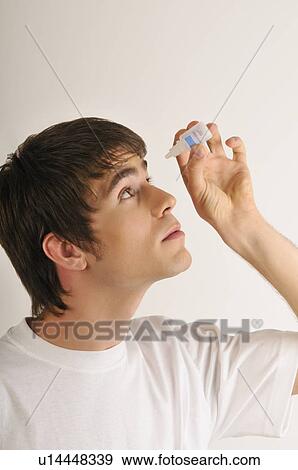 Stock Photo - Young male adult with Band-Aids over his eyes. Fotosearch