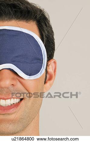 Young male adult with night shade over eyes View Large Photo Image Stock Image - Young male adult with night shade over eyes. Fotosearch
