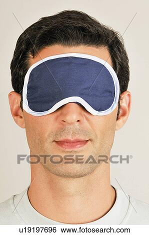 Young male adult with night shade over eyes View Large Photo Image Stock Photograph - Young male adult with night shade over eyes. Fotosearch