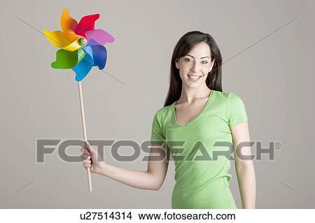 Young woman holding pinwheel View Large Photo Image Picture - Young woman holding pinwheel. Fotosearch