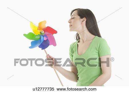 Young woman holding pinwheel View Large Photo Image Stock Photography - Young woman holding pinwheel. Fotosearch