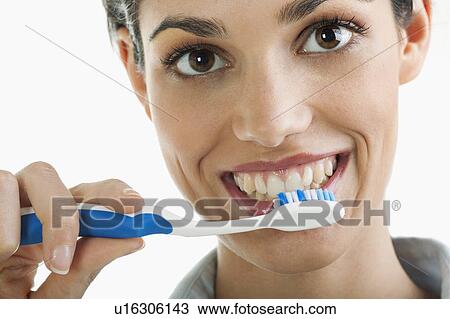 Stock Image - Young woman holding toothbrush. Fotosearch