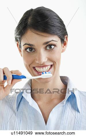Stock Photo - Young woman holding toothbrush. Fotosearch