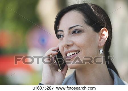 Young woman on smartphone View Large Photo Image Stock Photo - Young woman on smartphone. Fotosearch