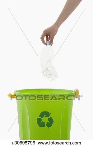 Young woman's arm throwing plastic bottle in the recycling bin View Large Photo Image Stock Photograph - Young woman's arm throwing plastic bottle in the recycling bin. Fotosearch