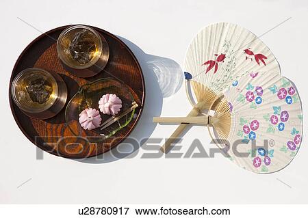 Stock Photo - Barley tea and sweet food on tray and fan. Fotosearch