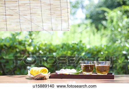 Stock Image - Barley Tea in glasses and sweet food. Fotosearch