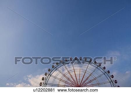 Stock Image - Blue Sky and Ferris Wheel. Fotosearch