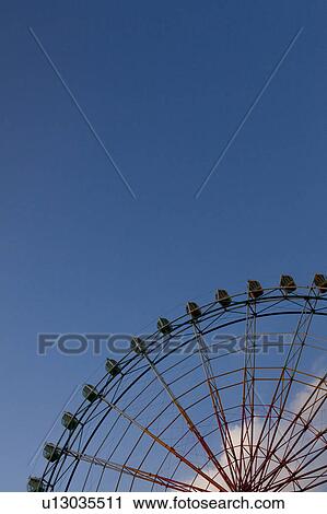 Stock Image - Blue Sky and Ferris Wheel. Fotosearch