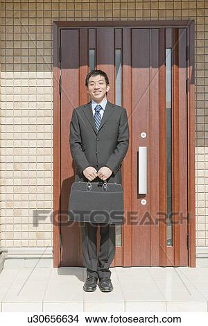 Businessman standing in front of house, Hyogo Prefecture, Honshu, Japan View Large Photo Image Picture - Businessman standing in front of house, Hyogo Prefecture, Honshu, Japan. Fotosearch