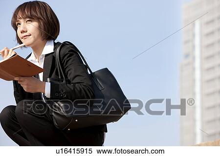 Businesswoman crouching and thinking View Large Photo Image Stock Photography - Businesswoman crouching and thinking. Fotosearch