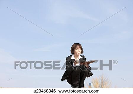 Businesswoman crouching holding diary and pen, Midsection View Large Photo Image Stock Photograph - Businesswoman crouching holding diary and pen, Midsection. Fotosearch