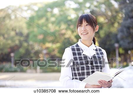 Stock Photo - Businesswoman holding an open book. Fotosearch