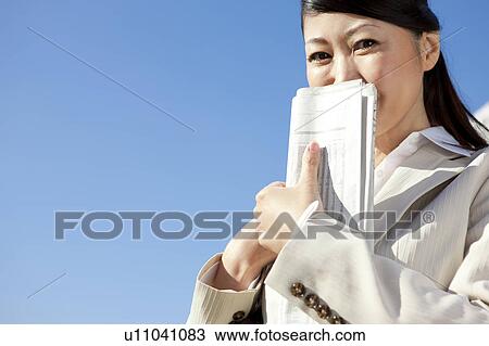 Businesswoman holding newspaper View Large Photo Image Stock Image - Businesswoman holding newspaper. Fotosearch