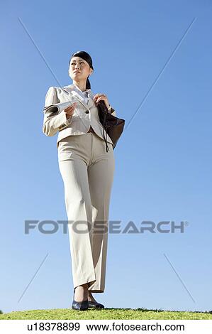 Stock Photo - Businesswoman holding newspaper. Fotosearch