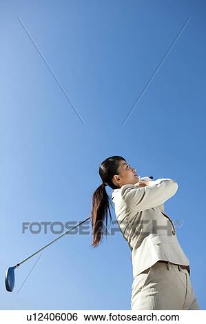 Businesswoman in suit playing golf View Large Photo Image Stock Photograph - Businesswoman in suit playing golf. Fotosearch
