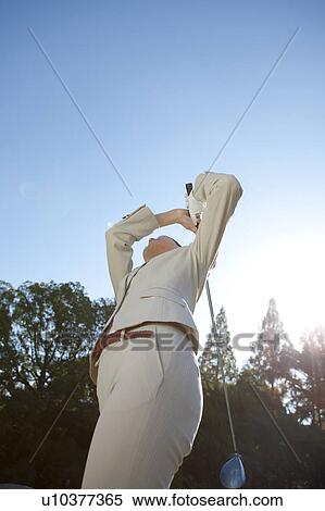 Businesswoman in suit playing golf View Large Photo Image Stock Photography - Businesswoman in suit playing golf. Fotosearch