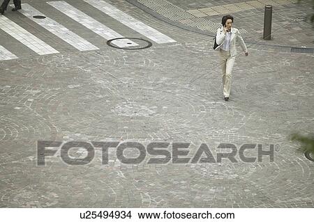 Businesswoman on cell phone, High Angle View View Large Photo Image Picture - Businesswoman on cell phone, High Angle View. Fotosearch