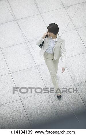 Businesswoman on cell phone, High Angle View View Large Photo Image Stock Photo - Businesswoman on cell phone, High Angle View. Fotosearch