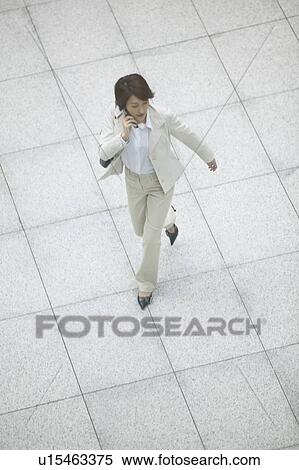 Stock Photography - Businesswoman on cell phone, High Angle View. Fotosearch