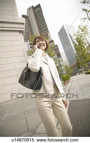 Businesswoman on cell phone, Low Angle View View Large Photo Image Stock Photography - Businesswoman on cell phone, Low Angle View. Fotosearch