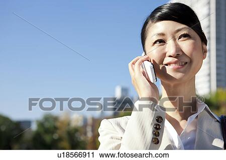 Stock Image - Businesswoman on cell phone. Fotosearch