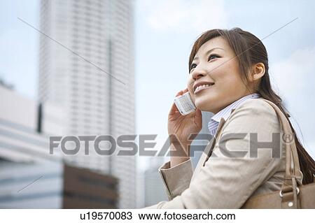 Stock Image - Businesswoman on cell phone. Fotosearch
