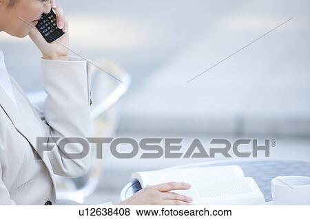 Stock Photo - Businesswoman on cell phone. Fotosearch