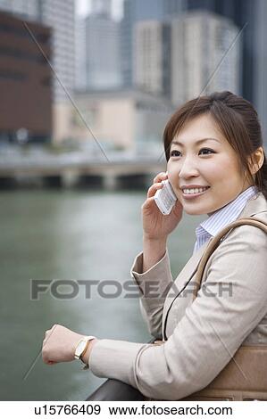 Stock Photo - Businesswoman on cell phone. Fotosearch