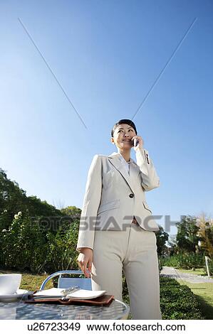 Stock Photo - Businesswoman on cell phone. Fotosearch