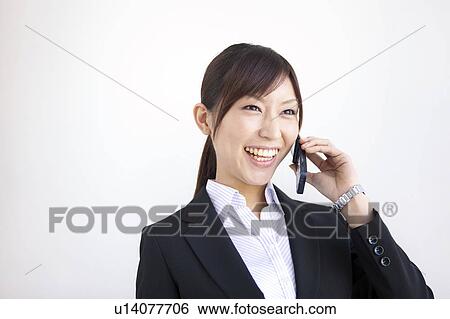 Stock Photograph - Businesswoman on cell phone. Fotosearch
