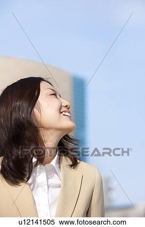 Businesswoman on rooftop smiling View Large Photo Image Stock Photography - Businesswoman on rooftop smiling. Fotosearch