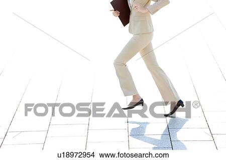 Picture - Businesswoman running, Low section. Fotosearch
