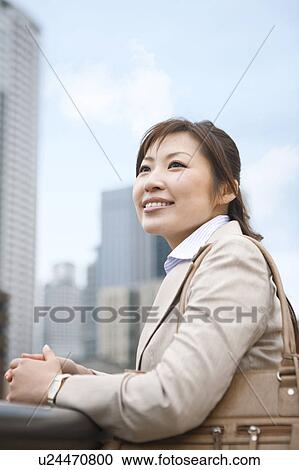 Stock Image - Businesswoman standing and looking. Fotosearch