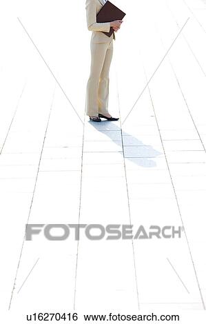 Businesswoman standing holding ring binder, Low section View Large Photo Image Stock Photograph - Businesswoman standing holding ring binder, Low section. Fotosearch