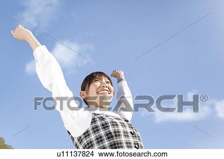 Picture - Businesswoman stretching, Low angle view. Fotosearch