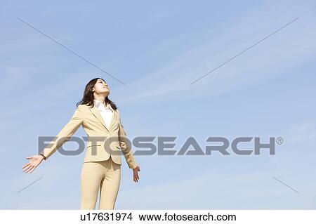 Picture - Businesswoman stretching on rooftop. Fotosearch
