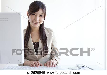 Businesswoman using a Desktop PC View Large Photo Image Stock Photograph - Businesswoman using a Desktop PC. Fotosearch