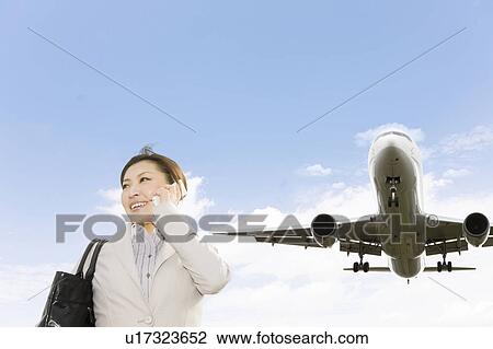 Businesswoman Using Phone Below Airplane View Large Photo Image Stock Image - Businesswoman Using Phone Below Airplane. Fotosearch