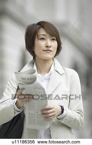 Stock Photograph - Businesswoman with newspaper. Fotosearch