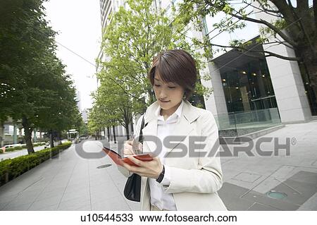 Businesswoman writing in diary View Large Photo Image Stock Image - Businesswoman writing in diary. Fotosearch