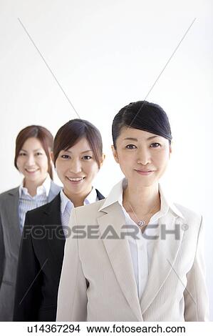 Businesswomen standing in a row smiling View Large Photo Image Picture - Businesswomen standing in a row smiling. Fotosearch
