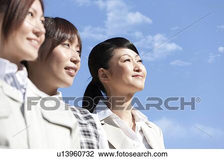 Businesswomen standing in a row smiling View Large Photo Image Stock Image - Businesswomen standing in a row smiling. Fotosearch