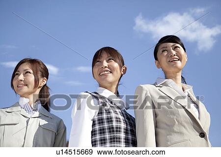 Businesswomen standing side by side smiling View Large Photo Image Stock Photo - Businesswomen standing side by side smiling. Fotosearch