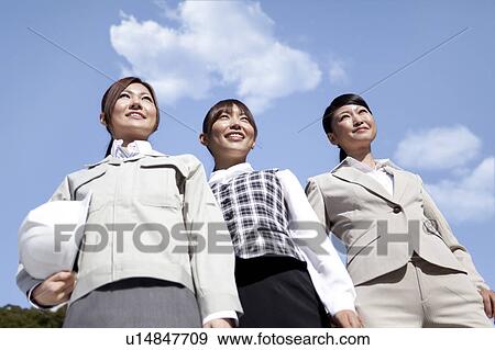 Businesswomen standing side by side smiling View Large Photo Image Stock Photo - Businesswomen standing side by side smiling. Fotosearch